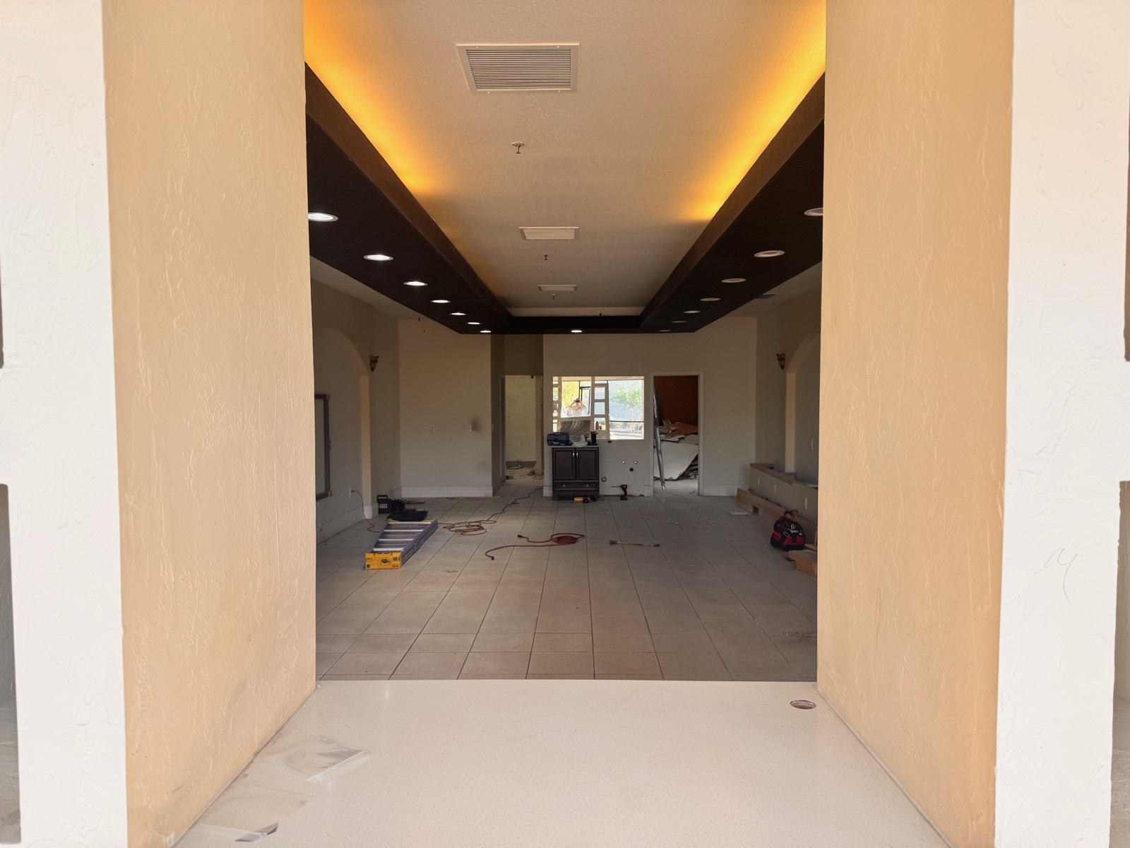 Before — entry archway and tiled floor of the space prior to the Reset Mind Body Tempe build-out, with the previous tenant's finishes still in place